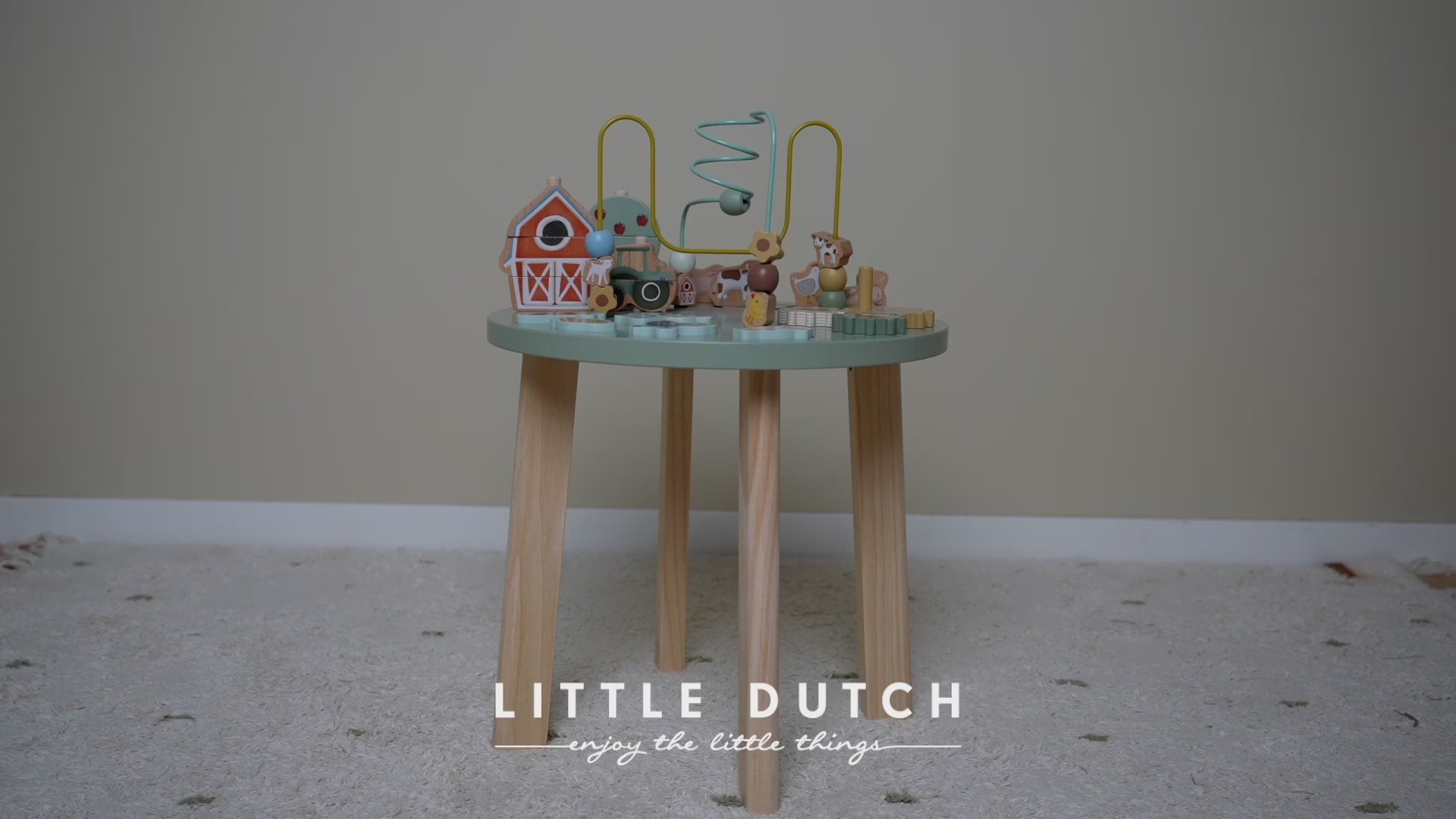 Load video: Video of the little dutch activity table - child exploring different activities on table