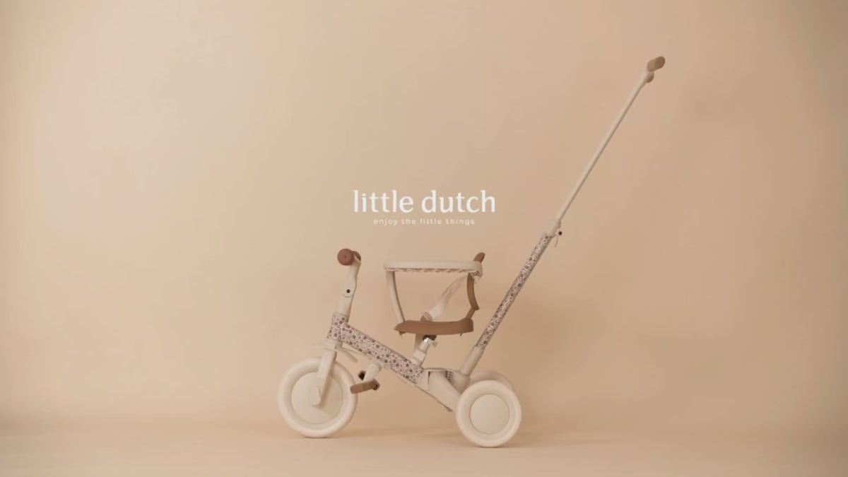 Video thumbnail showcasing the pink Little Dutch 4-in-1 toddler tricycle and balance bike against a warm, neutral studio backdrop.