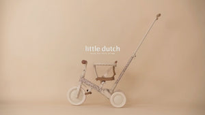 Video thumbnail showcasing the pink Little Dutch 4-in-1 toddler tricycle and balance bike against a warm, neutral studio backdrop.