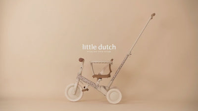 Video thumbnail showcasing the pink Little Dutch 4-in-1 toddler tricycle and balance bike against a warm, neutral studio backdrop.