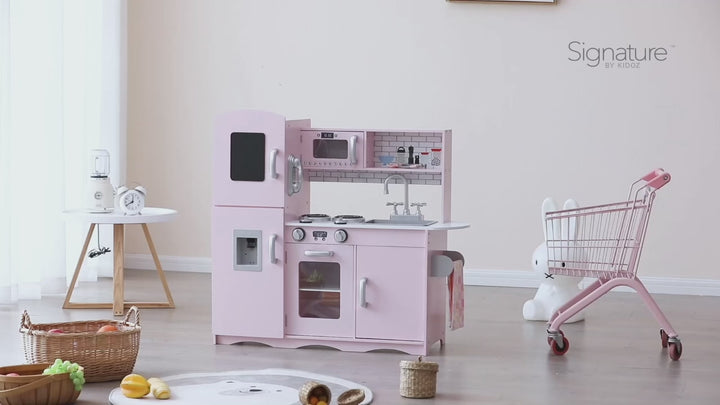 Video featuring a parent discussing their positive experience with the Deluxe Pink Wooden Play Kitchen. They highlight ease of assembly and their child's long-term enjoyment of the toy while scenes of the child playing are shown.