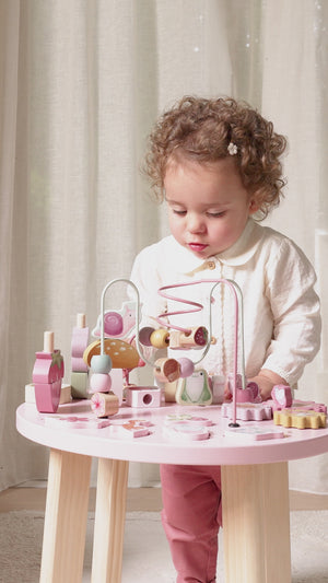 Child exploring different activities on table.