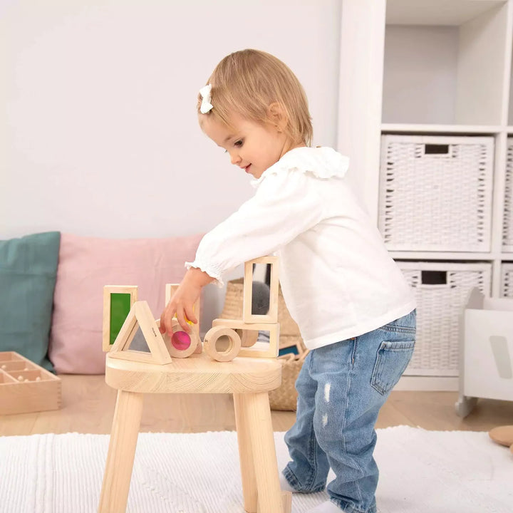 child playing with wooden toys