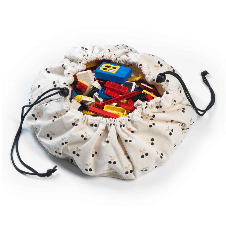 Tired of toy clutter battles? This adorable mini Play & Go bag with its cheerful cherry print is your secret weapon!
