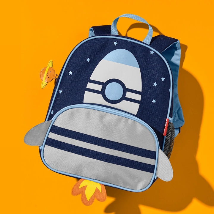 A skip hop blue backpack in a yellow background
