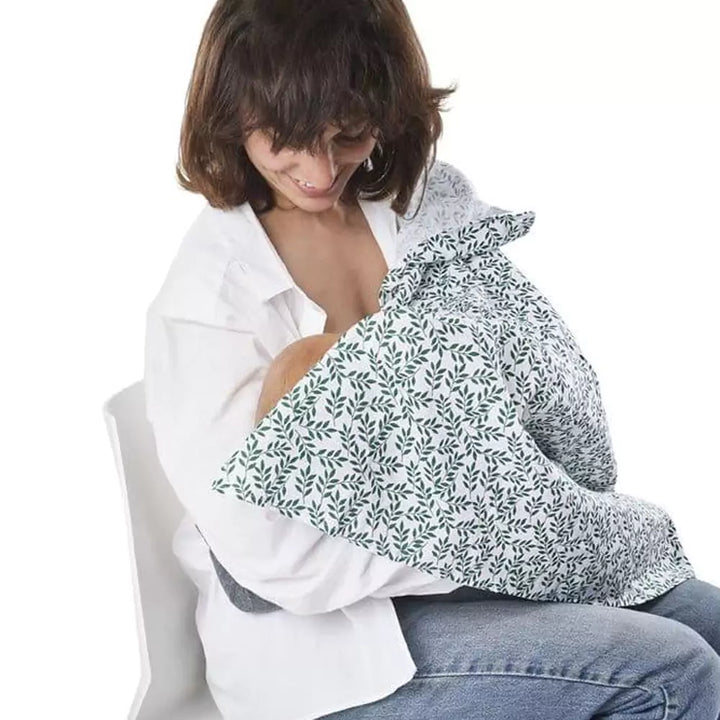 Mother nursing baby with swaddle