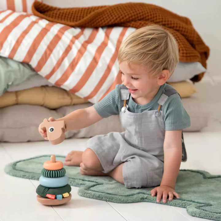 child playing with stacking toy