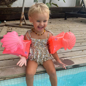 kids using Sunnylife Buddy Float Armbands displayed on a beach towel