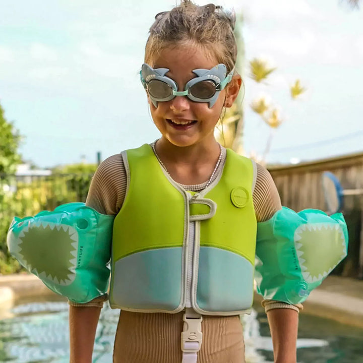 A kid wearing the Sunnylife Mini Swim Goggles featuring a playful Salty the Shark design, ready for a fun and safe swimming adventure.