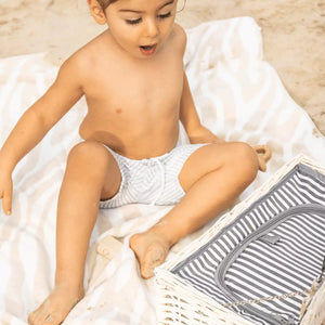 Child wearing the swimwear at the beach - Showcasing the trendy sailor look and highlighting the swimwear's comfort and style.