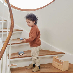 Kid playing with a toy screwdriver