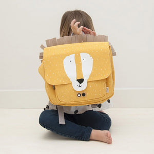 Preschooler smiles while wearing the Mr. Lion animal satchel backpack with a fluffy yellow mane.