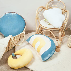 Soft nursery cushion with rainbow design, perfect for kids’ rooms
