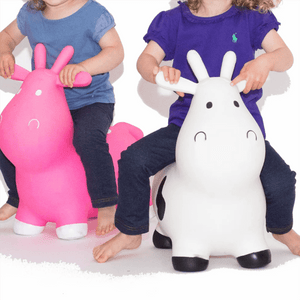 Two kids are playing with the Happy Hopperz ride toy