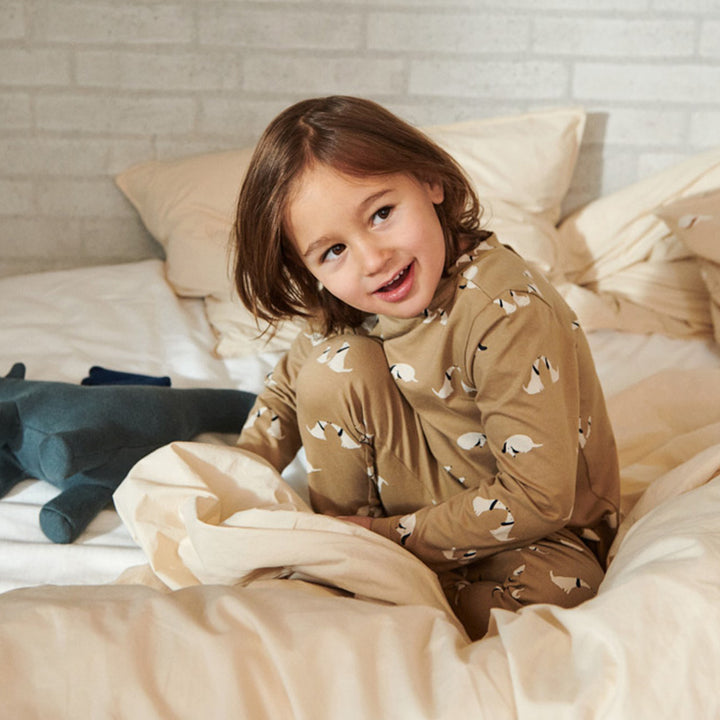 Girl wearing Liewood Wilhelm Printed Comfortable Bedtime Suit - Dog/Oat Mix